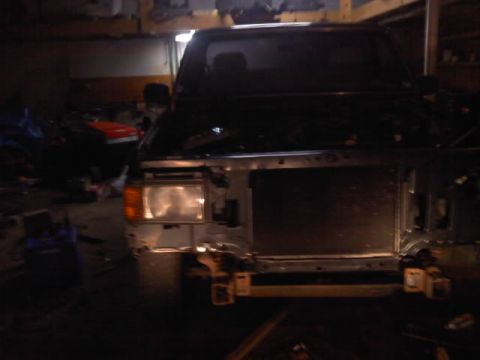 1994 Ford F-150 - Front view of a 1994 Ford F-150 undergoing front-end work in a garage.