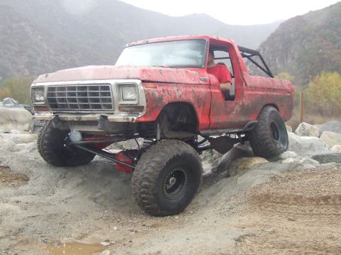 1978 Ford Bronco - This modified 1978 Ford Bronco navigates a rocky trail with its large tires and lifted suspension.