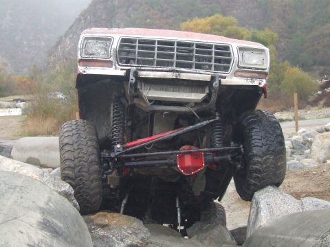 1978 Ford Bronco - This 1978 Ford Bronco is shown off-roading over large rocks with its suspension clearly visible.