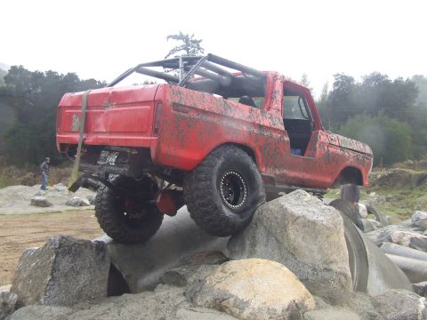 1978 Ford Bronco - This modified SUV is navigating a challenging rocky obstacle course.