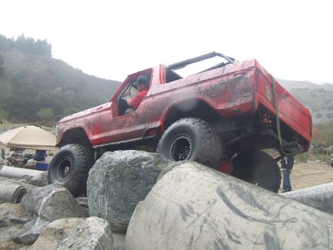1978 Ford Bronco - This off-road vehicle navigates a challenging rocky terrain, with a driver consulting a map.