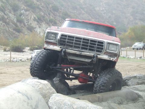 1978 Ford Bronco - This modified 1978 Ford Bronco is shown off-road, climbing over large rocks.