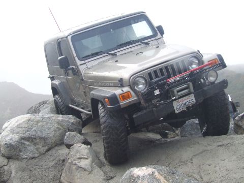 1978 Ford Bronco - Jeep Wrangler Rubicon navigating a difficult rocky obstacle course.