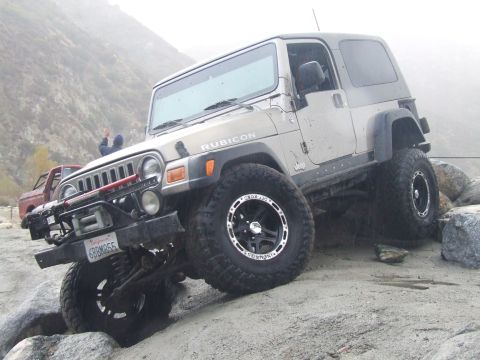 1978 Ford Bronco - A Jeep Wrangler Rubicon navigates a rocky trail with another vehicle visible in the background.