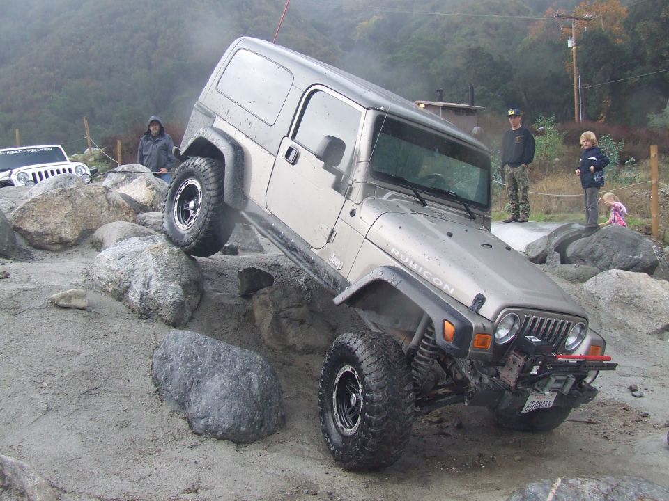 Silver Jeep Wrangler Rubicon navigating rocky terrain