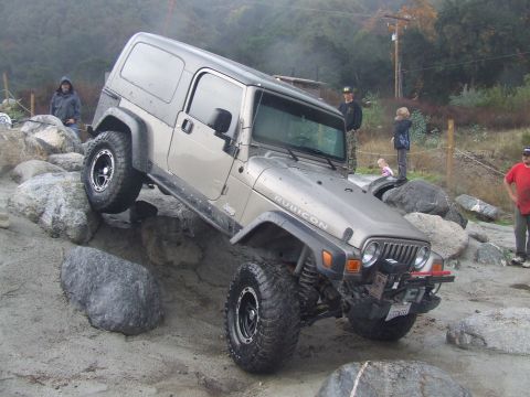 1978 Ford Bronco - A Jeep Wrangler Rubicon navigates a challenging rocky terrain.