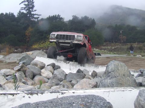 1978 Ford Bronco - A red 1978 Ford Bronco navigates a rocky obstacle course.