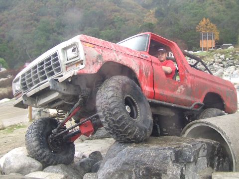 1978 Ford Bronco - This modified 1978 Ford Bronco navigates a challenging off-road course, demonstrating its impressive suspension and tire capabilities.