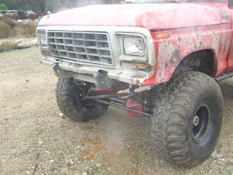 1978 Ford Bronco - This heavily modified truck features oversized tires and a custom bumper, with its grille indicating a 1978 model year.