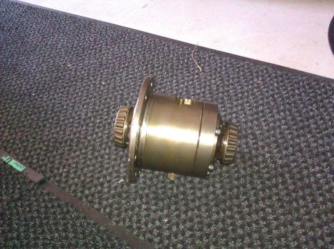 1995 Ford Bronco - A differential carrier with gears is shown on a carpeted surface.