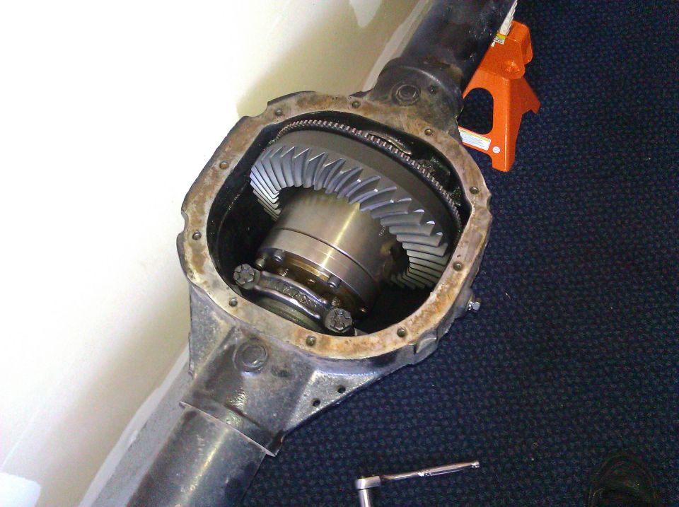 Differential housing with gears exposed. Orange jack stand in background