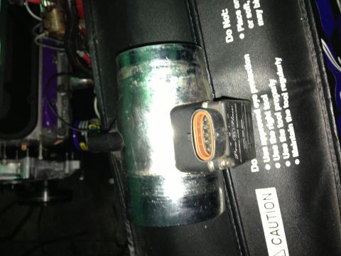 1988 Ford Bronco - Close-up of a Pro-Flow mass air flow sensor with visible text and an orange connector.