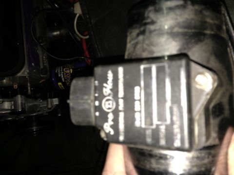 1988 Ford Bronco - A Pro-Flow mass air flow sensor is shown, with some text and part numbers visible on its casing.