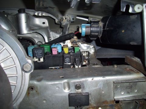 1995 Ford Probe - Close-up view of a vehicle's fuse box and associated wiring, showing various relays and connectors.