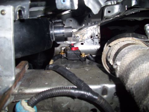 1995 Ford Probe - Automotive circuit breaker with red switch and connected wiring, part of an engine bay.