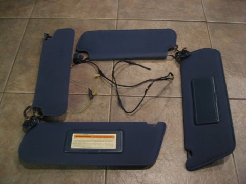1994 Ford F-150 - Set of four blue sun visors, likely for a truck or SUV, laid out on a tiled floor.
