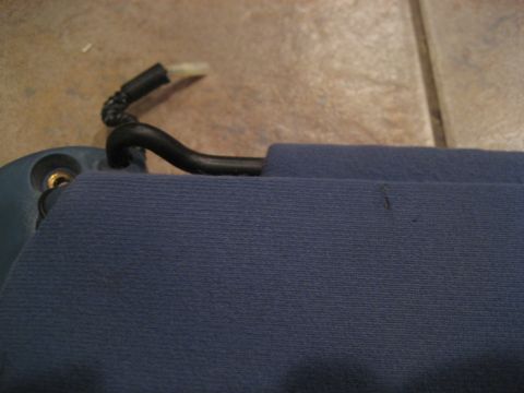 1994 Ford F-150 - Detail of a car sun visor and its mounting hardware, showing the clip mechanism.