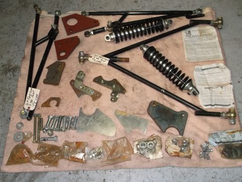 1971 Ford Ranchero - Various suspension components and hardware are displayed on a pink cloth, including shocks, control arms, and fasteners.