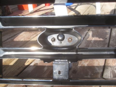 1993 Ford Bronco - Close-up of a 1993 Ford Bronco grille, highlighting its chrome and black finish and emblem mounting area.