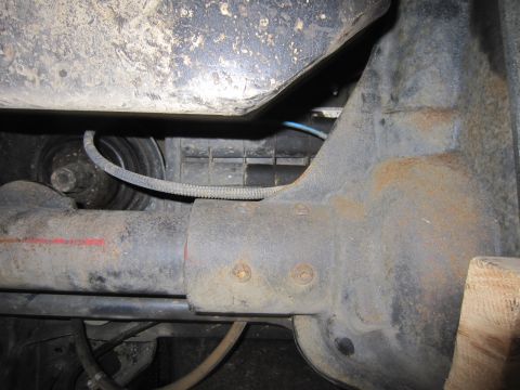 2008 Jeep Wrangler - This image shows a close-up view of a vehicle's axle and suspension system, with visible rust and some electrical wiring.