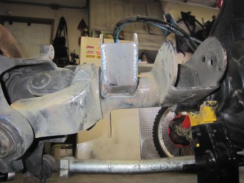 2008 Jeep Wrangler - Close-up view of a modified axle housing, showing suspension attachment points and welding work.