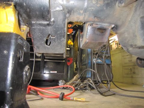 2008 Jeep Wrangler - Close-up of vehicle frame components with welding equipment and an air hose in a workshop.