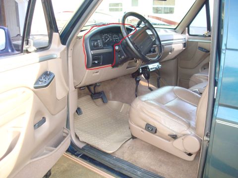 1995 Ford Bronco - The interior of a 1992 Ford Bronco shows tan leather seats, dashboard, and floor mats, with a CB radio visible.