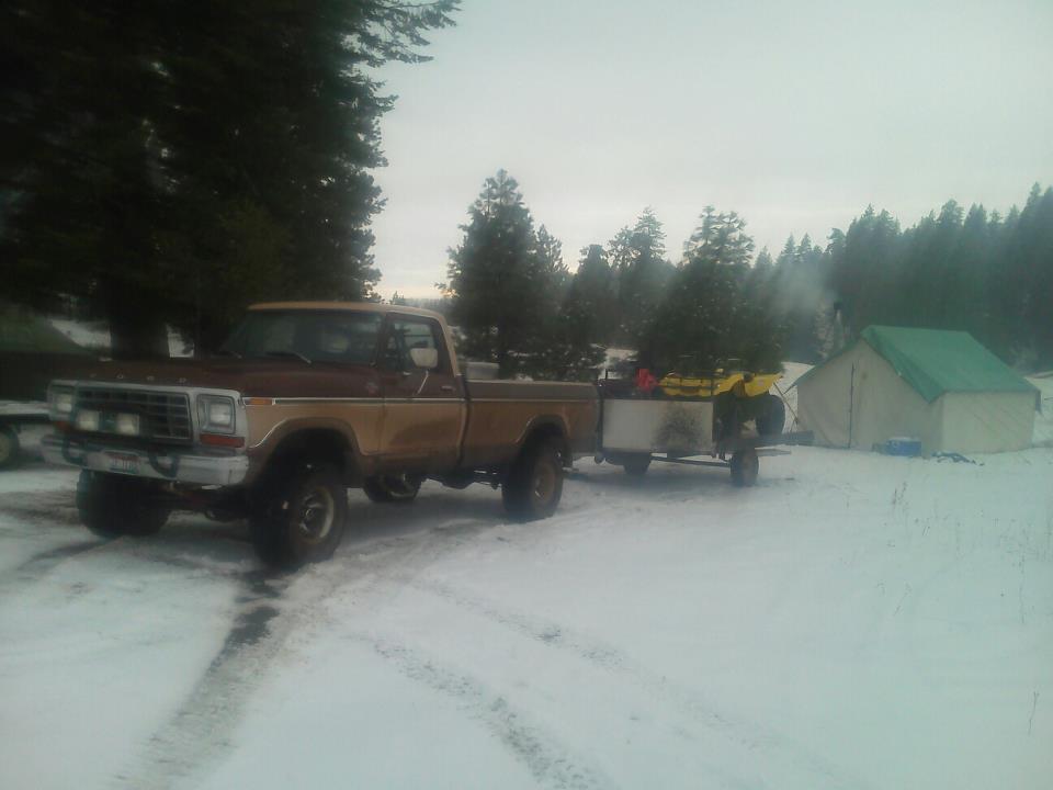 1979 Ford F-150 in snow towing trailer with ATV