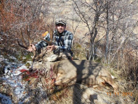 1979 Ford F-150 - Hunter poses with a large buck deer after a hunt in a natural outdoor setting.