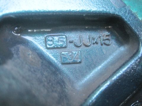 1993 Ford Bronco - A close-up view of a metal component showing stamped identification numbers and dimensions.
