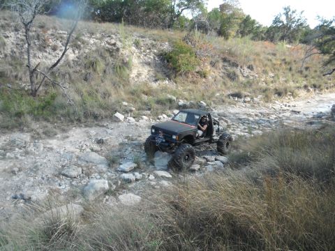 1979 Ford Bronco - Custom off-road vehicle navigates a challenging rocky trail.