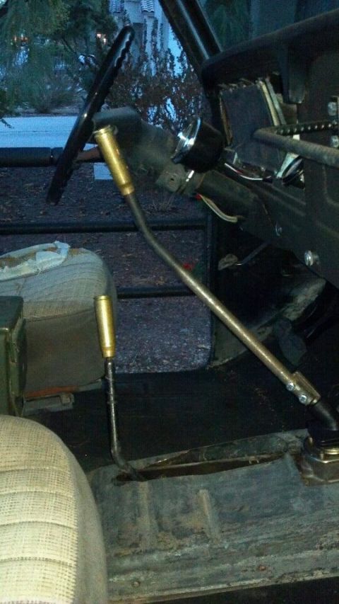 1978 Ford Bronco - The interior of a vehicle displays two distinct gear shifters, suggesting a non-standard transmission setup.