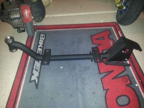 1978 Ford Bronco - A black hitch receiver part is displayed on a mat with 'BIKE TEK' and 'SUPERMOTORS' branding visible.