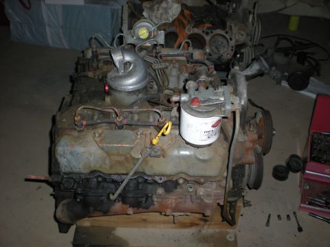 1986 Ford Bronco - Close-up of a diesel engine, likely a Ford IDI, with visible turbocharger and oil filter. Text is present on the filter.