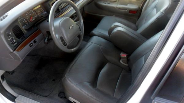 2001 Ford Crown Victoria interior showing dashboard, steering wheel, and front seats