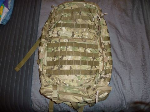 1992 Ford Mustang - Backpack with camouflage pattern and multiple straps and pockets.