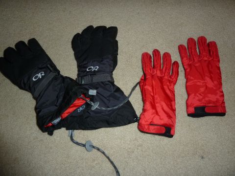 1992 Ford Mustang - Two pairs of ski gloves are laid out on a carpeted surface.