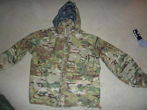 1992 Ford Mustang - A camouflage jacket is shown flat on a carpeted surface, with a flashlight nearby.