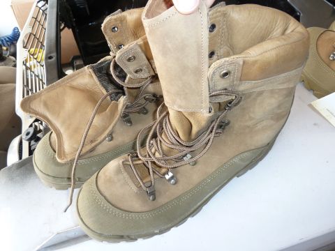 1992 Ford Mustang - Close-up of tan combat boots with laces and reinforced toe caps.