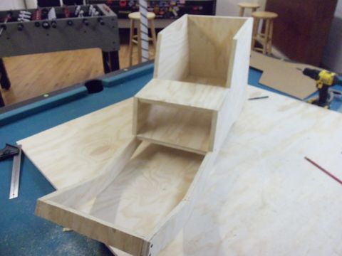 1985 Ford Bronco - A wooden structure is being built on a pool table, with a Supermotors.net logo visible in the lower right corner.