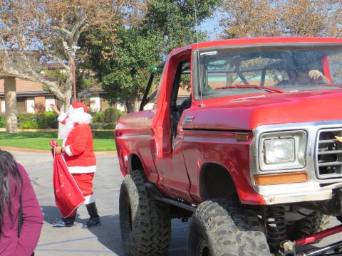 1978 Ford Bronco - A lifted 1978 Ford Bronco is seen with Santa Claus holding a sack of gifts.