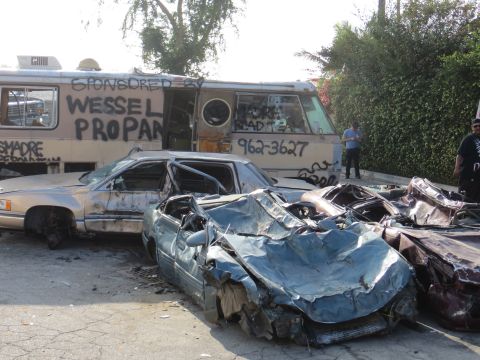 1978 Ford Bronco - A scene of destruction with multiple wrecked vehicles and a graffiti-covered bus.