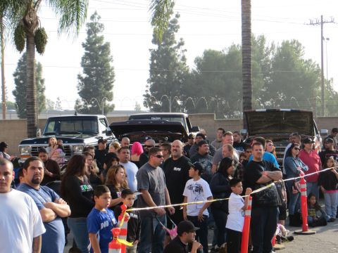 1978 Ford Bronco - A crowd gathers around a 1978 Ford Bronco and other vehicles at an outdoor event.