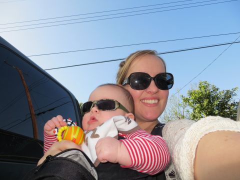 1978 Ford Bronco - A woman and a baby pose for a selfie while wearing sunglasses, with a vehicle in the background.