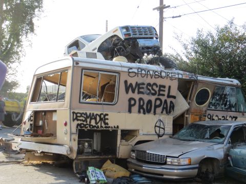 1978 Ford Bronco - A scene of destruction with a wrecked RV, a car on top, and another car crushed underneath.