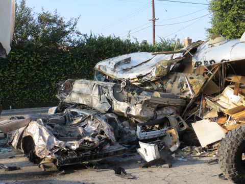 1978 Ford Bronco - The scene depicts a large pile of severely damaged vehicles, indicating a significant collision.