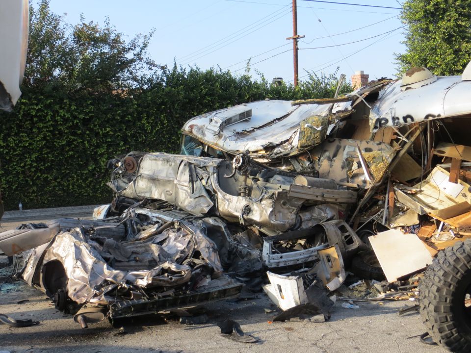 Pile of mangled car wreckage, looks like a multi-car crash aftermath
