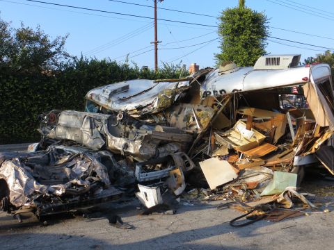 1978 Ford Bronco - The aftermath of a severe collision involving multiple vehicles and a trailer is visible on a street.