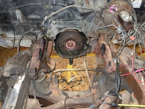 2001 Ford Crown Victoria - Underside view of engine and transmission parts, possibly during a repair or rebuild.