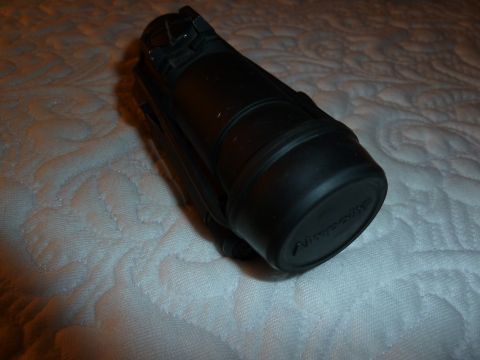 1992 Ford Mustang - A black Nitecore flashlight is shown resting on a textured white surface.